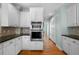 Modern kitchen with white cabinets, stainless steel appliances, and hardwood floors at 2883 Observation Nw Pt, Marietta, GA 30064