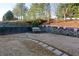 Well-maintained backyard with a stone path, white bench, and beautiful landscaping at 4030 Crescent Walk Ne Ln, Suwanee, GA 30024