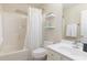 Bright bathroom with a shower-tub combination, white vanity, and fresh decor elements at 4030 Crescent Walk Ne Ln, Suwanee, GA 30024