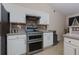 Bright kitchen featuring white cabinetry, stainless steel appliances, and neutral countertops at 4030 Crescent Walk Ne Ln, Suwanee, GA 30024