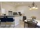 Bright kitchen with white cabinets, stainless steel appliances, and an adjacent breakfast area with seating at 4030 Crescent Walk Ne Ln, Suwanee, GA 30024