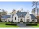 Stunning white brick home with a symmetrical design, arched entry, and manicured landscaping at 4380 Garmon Nw Rd, Atlanta, GA 30327