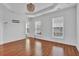 Empty bedroom featuring hardwood floors, a chandelier, tray ceilings, recessed lights and lots of natural light at 4874 Seldon Se Way, Smyrna, GA 30080