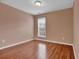 Cozy bedroom with laminate floors and a window providing natural light at 4874 Seldon Se Way, Smyrna, GA 30080