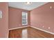 Cozy bedroom with laminate floors and a window providing natural light at 4874 Seldon Se Way, Smyrna, GA 30080