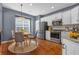 Eat-in kitchen features stainless steel appliances, white cabinets, granite countertops and a dining area with natural light at 4874 Seldon Se Way, Smyrna, GA 30080