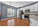 Eat-in kitchen features stainless steel appliances, white cabinets, and granite countertops at 4874 Seldon Se Way, Smyrna, GA 30080