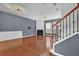 Inviting living room with staircase, hardwood floors, fireplace, and modern lighting fixtures at 4874 Seldon Se Way, Smyrna, GA 30080