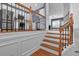 Elegant staircase with decorative iron railing leading to an open-concept kitchen and living area at 4874 Seldon Se Way, Smyrna, GA 30080