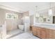 Elegant bathroom featuring a soaking tub, glass shower enclosure, and double vanity with marble countertop at 555 Orme Ne Cir, Atlanta, GA 30306