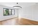 Well-lit bedroom with hardwood floors, large window, modern light fixture and paneled accent wall at 555 Orme Ne Cir, Atlanta, GA 30306