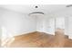 Bright bedroom with hardwood floors, modern light fixture, paneled accent wall, and three white doors at 555 Orme Ne Cir, Atlanta, GA 30306