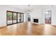 Spacious living room features hardwood floors, modern fixtures, a fireplace, and large windows providing natural light at 555 Orme Ne Cir, Atlanta, GA 30306