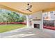Outdoor patio with stone floors, wood ceiling, ceiling fan, and herringbone fireplace overlooking the yard at 555 Orme Ne Cir, Atlanta, GA 30306