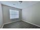 A cozy bedroom featuring light-colored walls and dark-toned wood flooring at 738 Windsor Cir, Lawrenceville, GA 30046