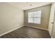 Cozy bedroom with a neutral palette, featuring wood-look floors and a bright window at 738 Windsor Cir, Lawrenceville, GA 30046