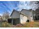 Side exterior featuring neutral siding, access door and view of a grassy yard at 738 Windsor Cir, Lawrenceville, GA 30046