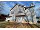 Exterior facade showing neutral siding, many windows and door leading to the yard at 738 Windsor Cir, Lawrenceville, GA 30046