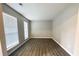 Inviting living space with wood-look floors and ample natural light from multiple windows at 738 Windsor Cir, Lawrenceville, GA 30046