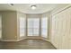 Bright living room showcasing a bay window and convenient closet space, enhanced by wood-look flooring at 738 Windsor Cir, Lawrenceville, GA 30046