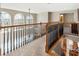 Open hallway with railing overlooking the entry; beautiful windows provide lots of natural light at 8850 Appling Rdg, Cumming, GA 30041