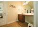 Bright bathroom vanity with wooden cabinets, tiled floor, and decor on the counter at 1092 Park Hollow Ln, Lawrenceville, GA 30043