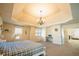 Spacious bedroom with tray ceiling, chandelier and an adjoining living room at 1092 Park Hollow Ln, Lawrenceville, GA 30043