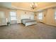 Expansive primary bedroom with tray ceiling and lots of natural light at 1092 Park Hollow Ln, Lawrenceville, GA 30043