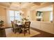 Inviting dining area with an 'EAT' sign and views of the living room showcasing an open concept design at 1092 Park Hollow Ln, Lawrenceville, GA 30043