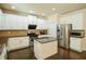 Modern kitchen with white cabinets, granite countertops, stainless steel appliances, and a kitchen island at 1092 Park Hollow Ln, Lawrenceville, GA 30043