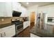 Modern kitchen featuring white cabinets, granite countertops, and stainless steel appliances with pantry at 1092 Park Hollow Ln, Lawrenceville, GA 30043