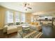 Bright living room featuring a large sectional sofa, hardwood floors, and natural light at 1092 Park Hollow Ln, Lawrenceville, GA 30043