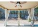 Covered patio with curtains, ceiling fan, and view of the backyard and trees at 1092 Park Hollow Ln, Lawrenceville, GA 30043