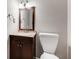 Bathroom with granite sink, wood vanity, wood framed mirror and toilet at 2941 Foothill Trl, Marietta, GA 30066