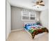 Bright bedroom featuring ceiling fan, carpet flooring, closet and window at 2941 Foothill Trl, Marietta, GA 30066