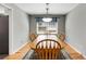 Cozy dining room with hardwood floors, a wooden table, and a stylish light fixture at 2941 Foothill Trl, Marietta, GA 30066