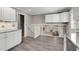 Kitchen view with white cabinets, granite countertops, and stairs to the lower level at 2941 Foothill Trl, Marietta, GA 30066