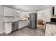 Stylish kitchen featuring white cabinetry, stainless steel appliances, and views of the dining area at 2941 Foothill Trl, Marietta, GA 30066