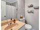 Simple bathroom featuring tile floors, single sink vanity, mirror and toilet at 5545 Circlestone Ln, Stone Mountain, GA 30083