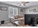 This bedroom features a cozy couch, large window, and a ceiling fan for optimal comfort at 5545 Circlestone Ln, Stone Mountain, GA 30083