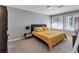 Bright bedroom featuring carpet, neutral walls, a large bed, and windows with natural light at 5545 Circlestone Ln, Stone Mountain, GA 30083