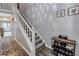 Inviting hallway with staircase, shoe rack, and decorative accents at 5545 Circlestone Ln, Stone Mountain, GA 30083