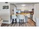 Kitchen featuring stainless steel appliances, a breakfast bar, white cabinets, and stylish backsplash at 5545 Circlestone Ln, Stone Mountain, GA 30083