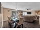 Open-concept living room featuring a dining area, dark wood floors, and a comfortable sectional sofa at 5545 Circlestone Ln, Stone Mountain, GA 30083