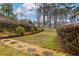 Lush backyard featuring mature trees and a rock path at 1341 Inman Ct, Norcross, GA 30093