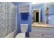 Well lit bathroom featuring a tub with floral shower curtain and built in storage at 1341 Inman Ct, Norcross, GA 30093