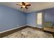 This spacious bedroom has wood flooring, an accent rug, and a ceiling fan at 1341 Inman Ct, Norcross, GA 30093