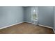 This cozy bedroom features neutral paint, plush brown carpeting, and a bright window dressed with patterned curtains at 1341 Inman Ct, Norcross, GA 30093