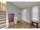 Bright foyer with wood-look flooring, staircase, and white front door at 1341 Inman Ct, Norcross, GA 30093