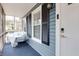 A cozy screened-in front porch with blue carpeting and exterior at 1341 Inman Ct, Norcross, GA 30093